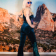 blonde woman in a deep teal jumpsuit